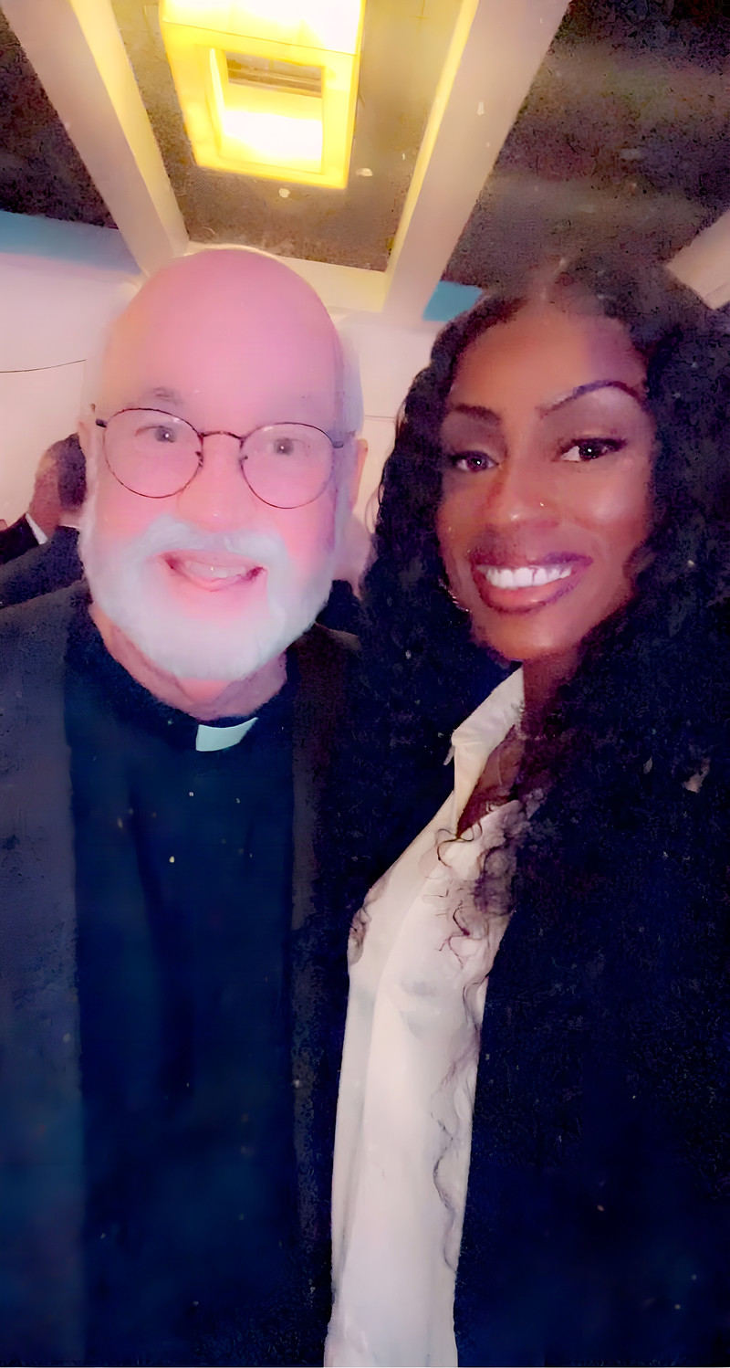 Janay Lewis smiling with a guest at a formal gala