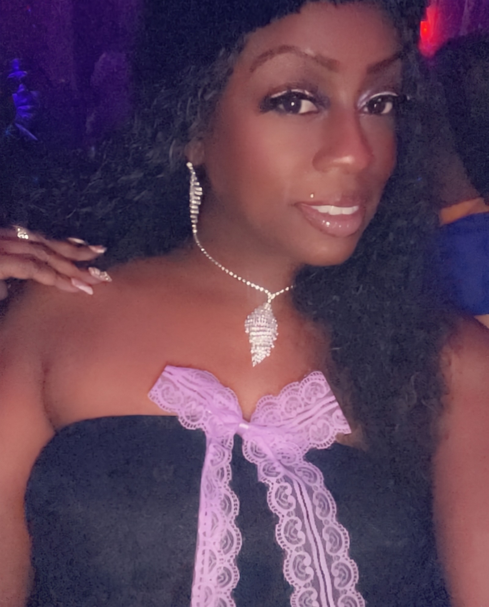 Janay Lewis on her birthday night in a black strapless top with a lavender lace bow