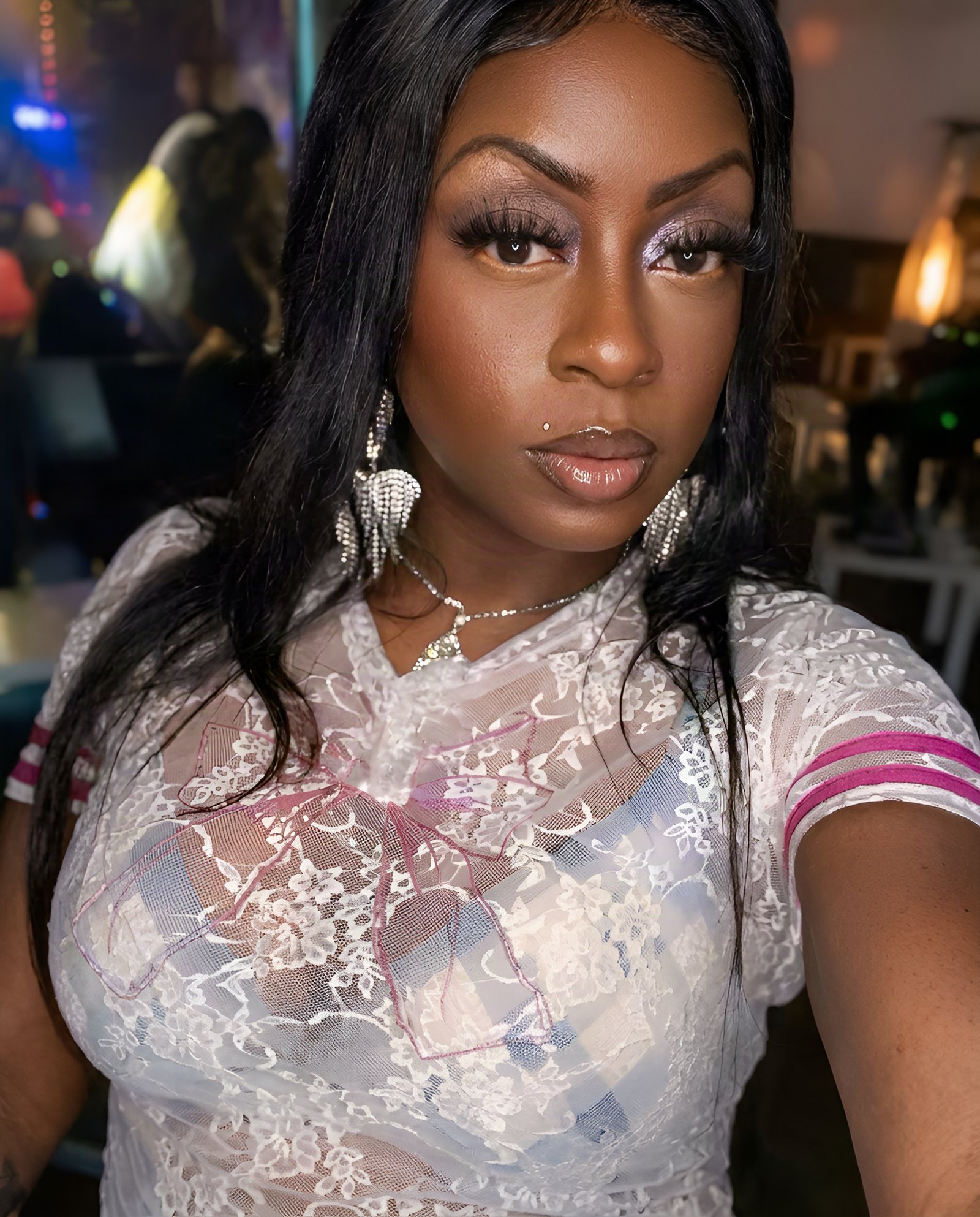 Janay Lewis on a Saturday night in white lace under club lights