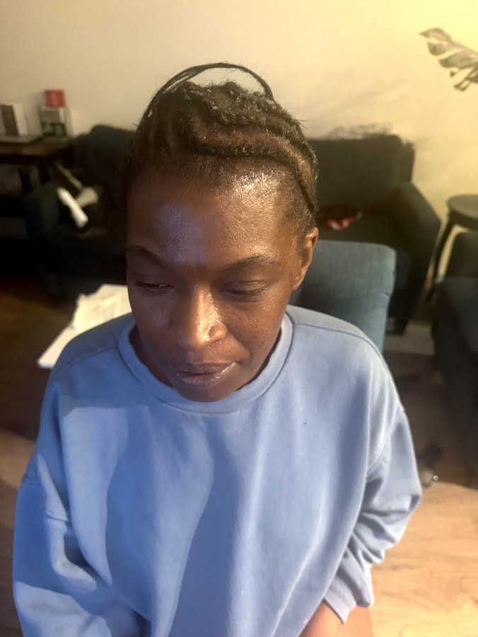 Client before her appointment, hair pulled back