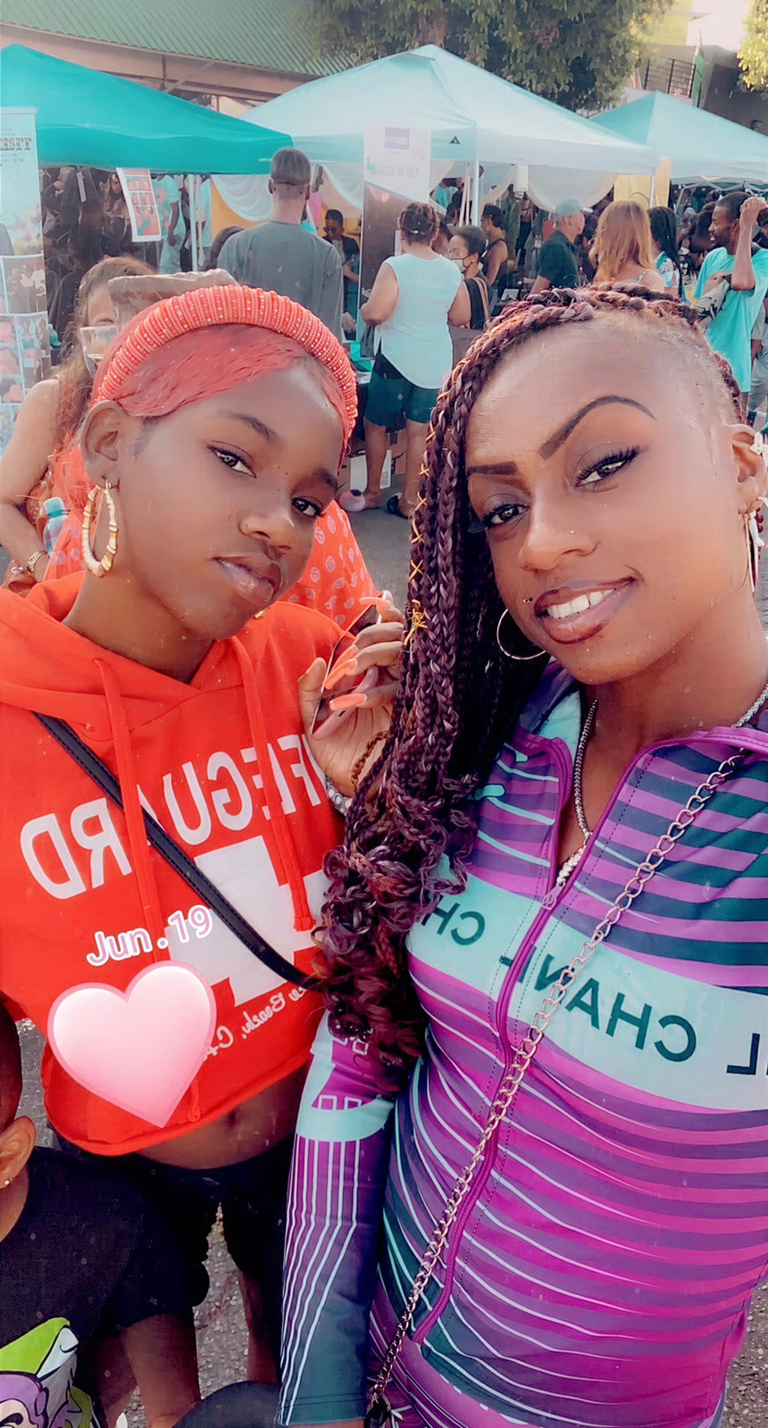 Janay Lewis outdoors in her own burgundy braids